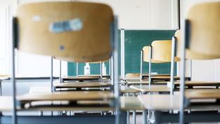 Stühle sind in einem leeren Klassenraum hochgestellt. (Foto: picture alliance/dpa | Oliver Berg)
