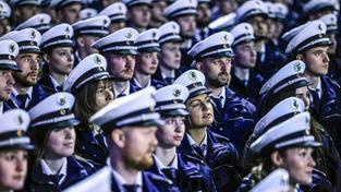 Zahlreiche Polizisten und Polizistinnen stehen bei ihrer Dienst-Vereidigung in Uniform bereit (Foto: picture alliance/dpa | Oliver Berg)