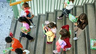 Kinder mit Schultüten laufen eine Treppe hinab (Foto: IMAGO / photonews.at)